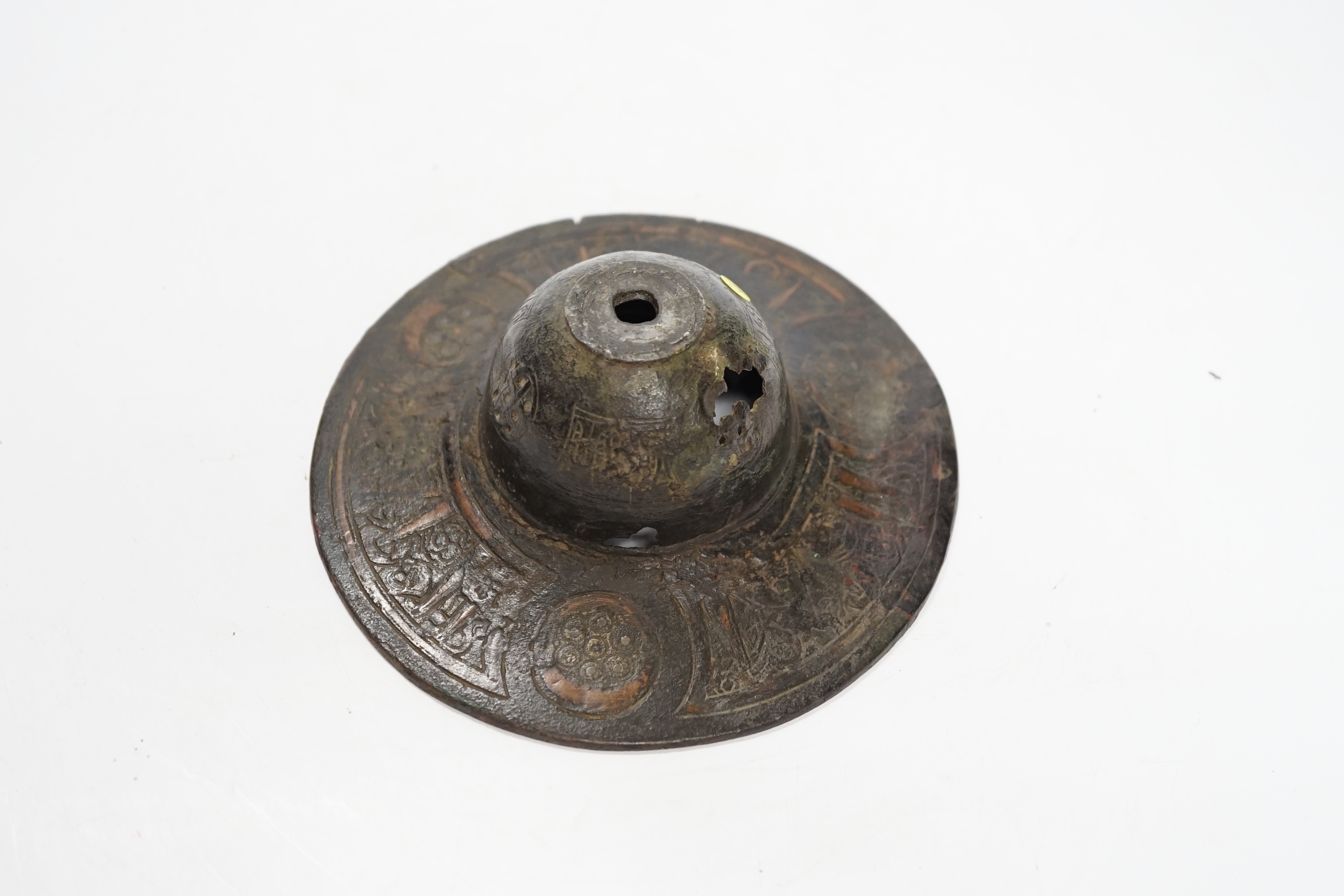 An early Islamic bronze and copper inlaid shield or door boss, probably 12th/13th century, 14.5cm